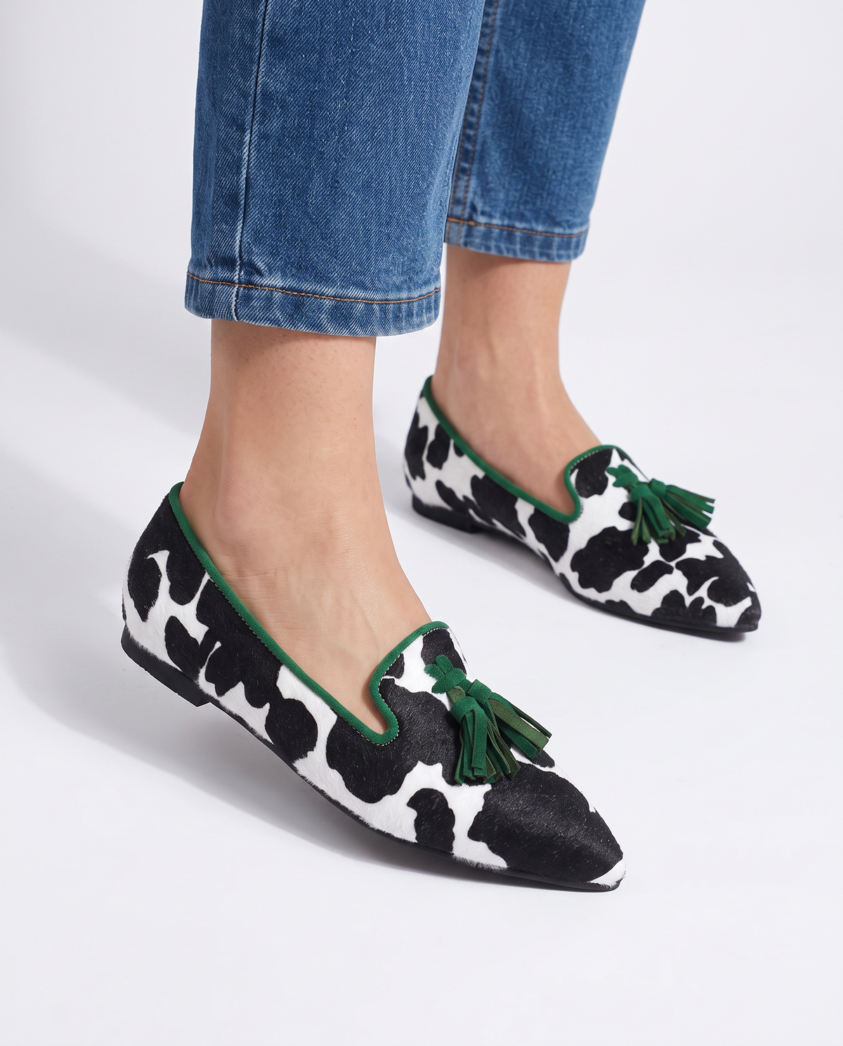 Ginevra Moccasin — Black and White Cow Print, Green Tassels